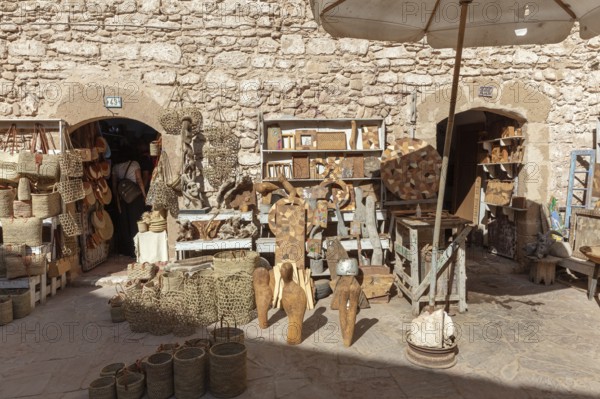 Handicraft market in an area surrounded by stone walls with traditional crafts and statues