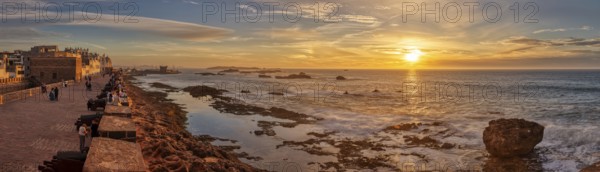 Panoramic sunset view over the sea with city view in the background