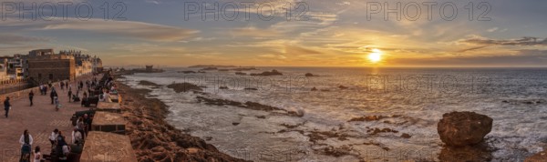 Atmospheric panorama of sunset over the coast with city view