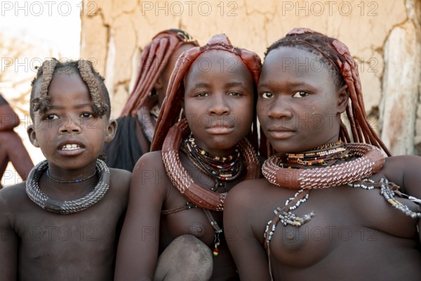 Group of Himba people, Himba woman, traditional Himba village, Kaokoveld, Kunene, Namibia