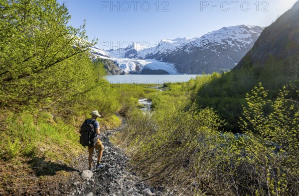 Hikers on the Portage Pass Trail, snowy mountains, Portage Glacier and Portage Lake, near Whittier, Alaska, USA
