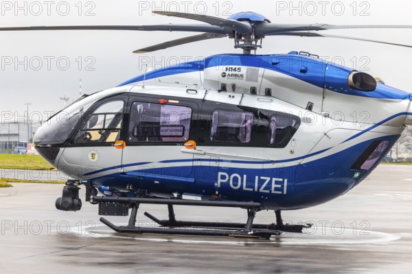 Helicopter from the Baden-Württemberg Police team in front of the hangar at the airport. Airbus Helicopters H145. Stuttgart, Baden-Württemberg, Germany
