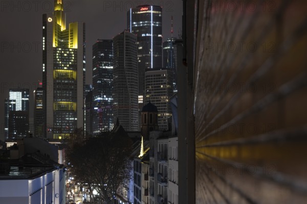 A yellow heart glows on the façade of the Commerzbank Tower in Frankfurt am Main at Christmas time in the evening, Frankfurt am Main, Hesse, Germany