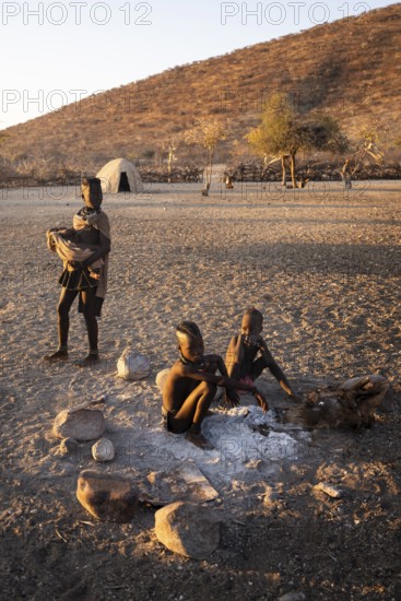 Himba children at the fire early in the morning, traditional Himba village, Kaokoveld, Kunene, Namibia