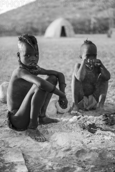 Black and white, Himba children at the fire early in the morning, traditional Himba village, Kaokoveld, Kunene, Namibia