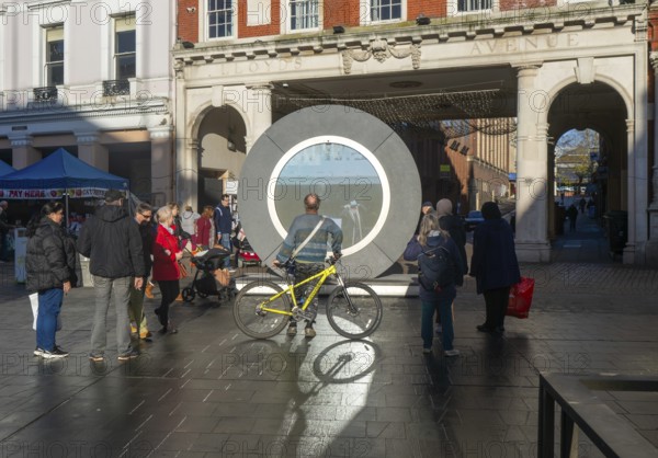 People on the Cornhill in the town centre view the first ever UK Portal in Ipswich, Suffolk, England, UK