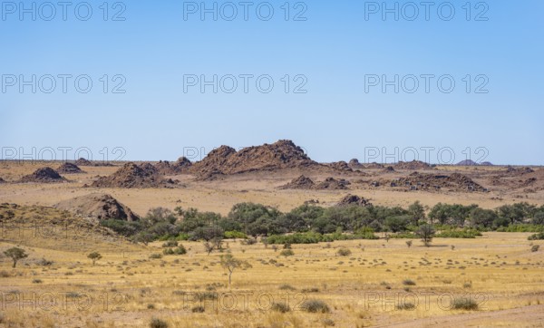 Desert landscape, barren landscape with hills of stacked rocks, Ugab River riverbed, Brandberg, Erongo, Damaraland, Namibia
