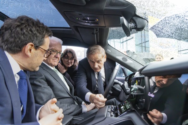 Annual event on the BW Automotive Industry Strategy Dialogue (SDA) in Stuttgart. Winfried Kretschmann, (Greens, Minister-President BW) and Stéphane Séjourné (Executive Vice President of the European Commission and Commissioner for Prosperity and Industrial Strategy) in a Porsche Cayenne. Porsche boss Oliver Blume. Automotive industry conference. Stuttgart, Baden-Württemberg, Germany