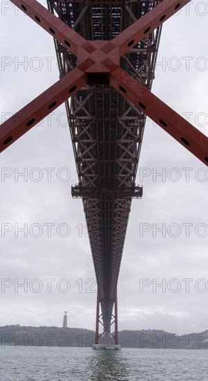 The Ponte 25 de Abril, 3.2 km long bridge in Portugal with a 2278 meter long suspension bridge across the Tagus, cloudy and rainy weather, third-longest suspension bridge with combined road and rail traffic, Lisbon, Portugal