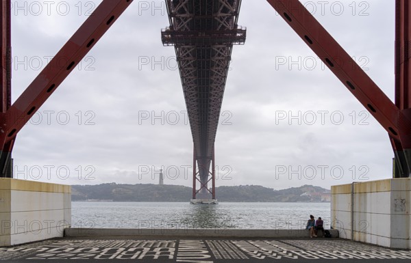 The Ponte 25 de Abril, 3.2 km long bridge in Portugal with a 2278 meter long suspension bridge across the Tagus, cloudy and rainy weather, third-longest suspension bridge with combined road and rail traffic, Lisbon, Portugal