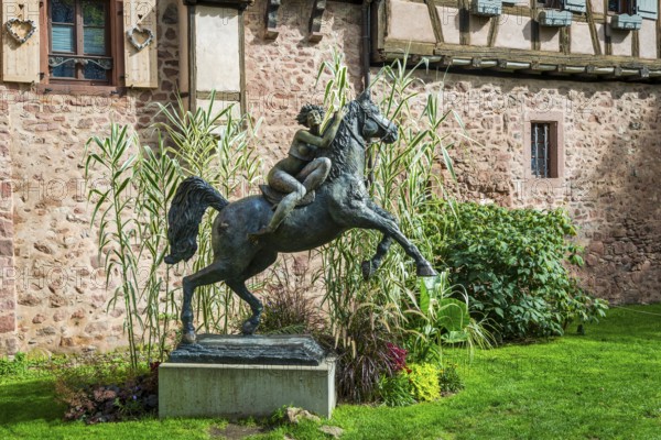 Statue of a woman riding with horse La Dame du Parc in Riquewihr