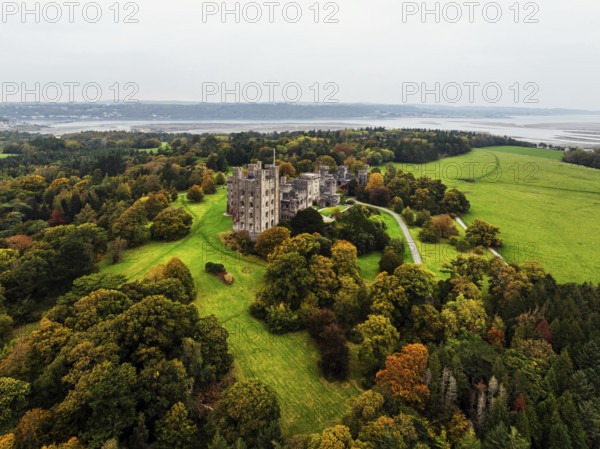 Autumn colours over Penrhyn Castle and Garden from a drone, Llandygai, Bangor, Gwynedd, North Wales, UK