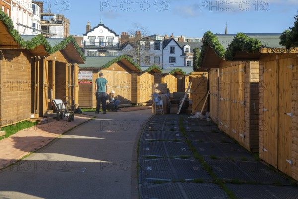 Wooden sheds being prepared for Exeter Cathedral Christmas Market, Exeter, Devon, England, UK