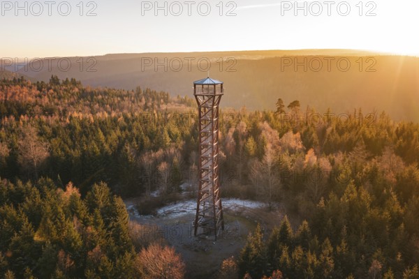 An observation tower stands in an autumnal forest at sunrise, Hohe Warte lookout tower, Hohenwart, Pforzheim, Germany
