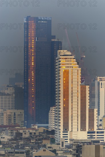 Panorama from the Iconsiam viewing platform of skyscrapers of the Bangrak banking district at sunset, skyline of Bangkok, Thailand