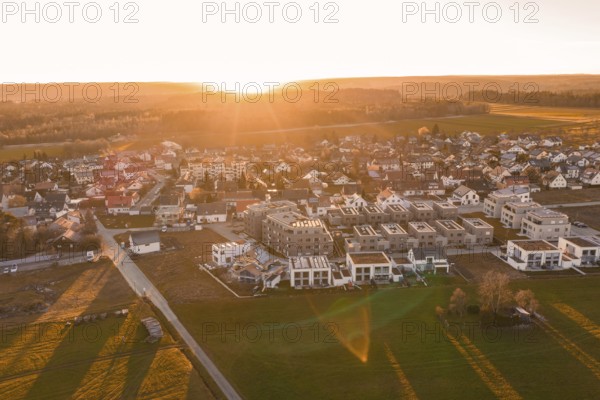 Extensive village with modern new buildings and fields at sunset, Althengstett, Calw district, Germany