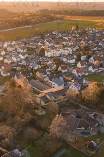 Aerial view of a village at dusk surrounded by fields and forests, Althengstett, Calw district, Germany