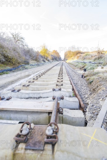 Straight tracks lead through an autumn landscape into fog, track construction of the Hermann Hesse Railway, Calw, Germany