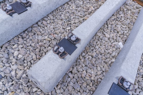 Detailed view of concrete sleepers and their metal fastenings on gravel, track construction of the Hermann Hesse Railway, Calw, Germany