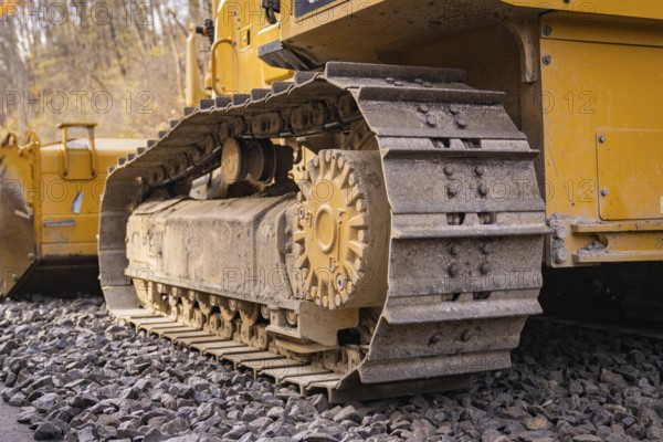 Close-up of a chain tractor on gravel, part of construction, track construction of the Hermann Hesse Railway, Calw, Germany