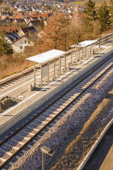 Station with platform and tracks in rural surroundings, surrounded by autumn landscape, new Hermann Hessebahn railway station, Ostelsheim, Calw district, Germany