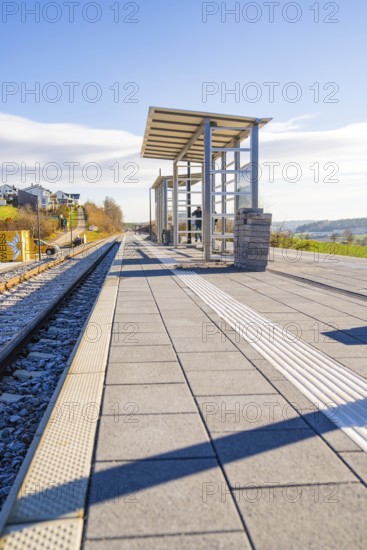 Spacious railway platform with panoramic views of nature and sun, new Hermann Hessebahn railway station, Ostelsheim, Calw district, Germany