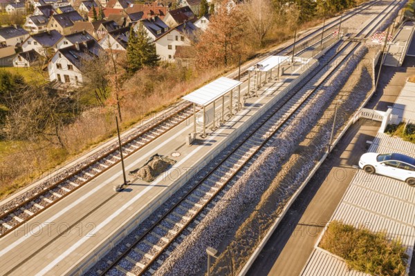 Station environment with platforms and apartments, autumnal atmosphere, drone image with parked car, new Hermann Hessebahn station, Ostelsheim, Calw district, Germany