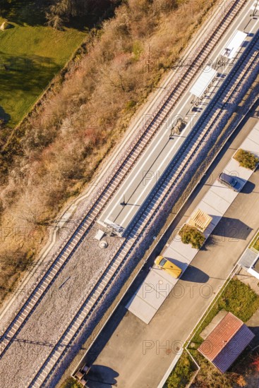 Railway line and platform in rural surroundings, with surrounding roads and vegetation, new Hermann Hessebahn station, Ostelsheim, Calw district, Germany