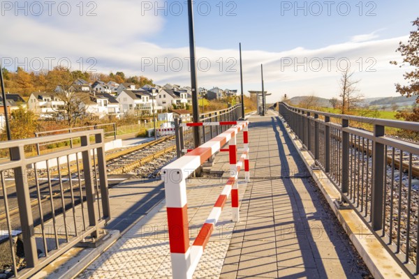 Footbridge with barrier in a modern environment, new Hermann Hessebahn railway station, Ostelsheim, Calw district, Germany