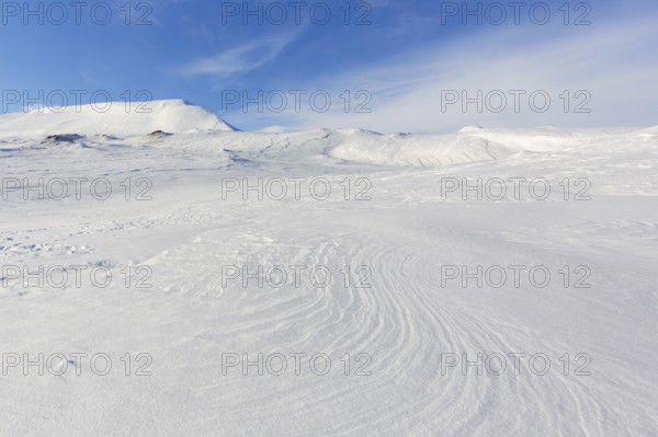 Desolate windswept snow covered Arctic landscape at Mohnbukta, bay at the western shore of Storfjorden in Sabine Land at Spitsbergen, Svalbard