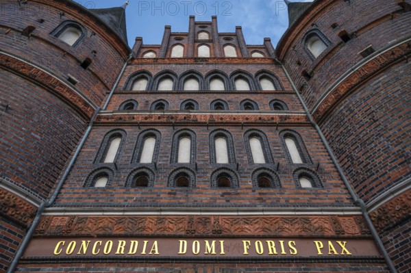 Concodia Domini Fotris Pax: The harmony of the Lord, the peace of the father, a saying at the Holsten Gate, historic city gate from 1478, Holstentorplatz, Hanseatic City of Lübeck, Schleswig-Holstein, Germany