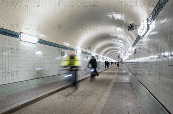 Interior view, pedestrians and cyclists crossing tunnel, mopping effect, movement, tube, historic old Elbe Tunnel, Free and Hanseatic City of Hamburg, Germany