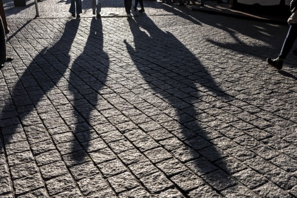 Shadows of people on the ground, low sun, winter, silhouettes, Germany