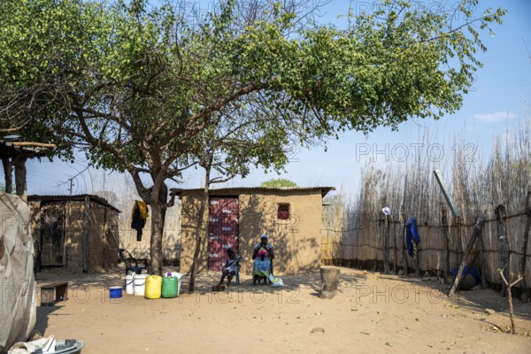 Locals in a typical village with clay huts, Caprivi Strip, Namibia