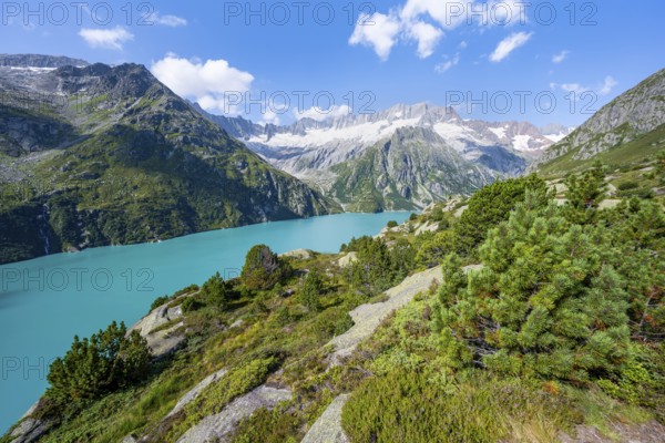 Turquoise blue mountain lake Göscheneralpsee, picturesque mountain landscape with dammastock and damma glacier, Göscheneralp, Canton of Uri, Switzerland