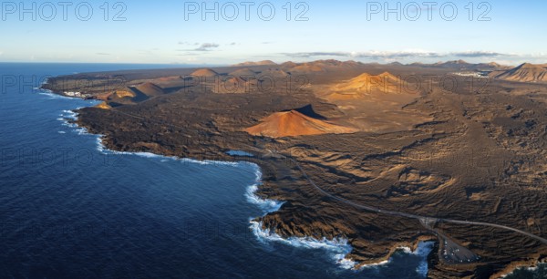 Coast with lava fields, volcanic landscape near Los Hervideros with red volcano Montaña Bermeja, in the evening light, aerial view, Lanzarote, Canary Islands, Spain