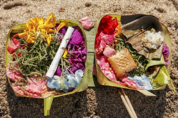Canang Sari is a Balinese offering that expresses Wasa (God) or the creators of life to Sang Hyang Widhi. The offerings are used to balance and maintain peace on earth, between good and evil, between gods and demons, between heaven and hell, Kuta beach, Bali, Indonesia