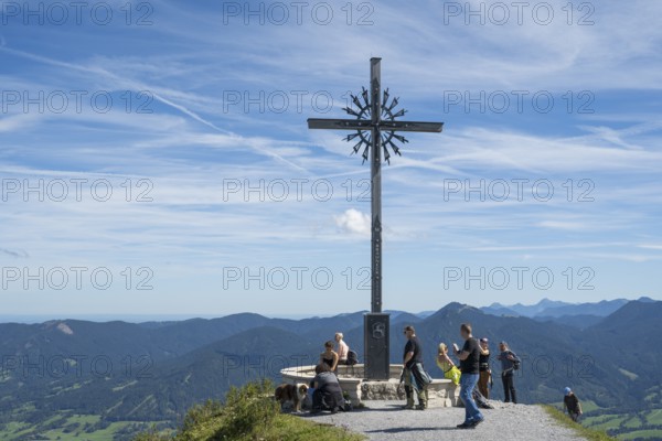 Summit cross with tourists, Brauneck 1555m, Bavarian Prealps, Isarwinkel, Lenggries, Upper Bavaria, Bavaria, Germany