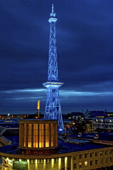 Blue-lit Berlin radio tower, steel half-timbered building by architect Heinrich Straumer, Langer Lulatsch, old radio tower, television tower, heritage-protected building, in front of Hall 16, exhibition center, Messe Berlin, dusk, blue hour, Berlin, Germany