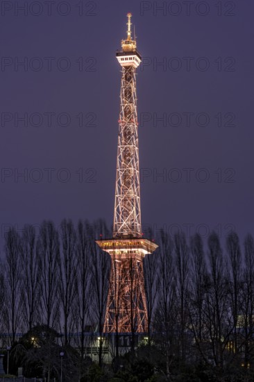 Red illuminated Berlin radio tower, half-timbered steel building by architect Heinrich Straumer, Langer Lulatsch, old radio tower, television tower, heritage-protected building, exhibition center, Messe Berlin, dusk, blue hour, Berlin, Germany