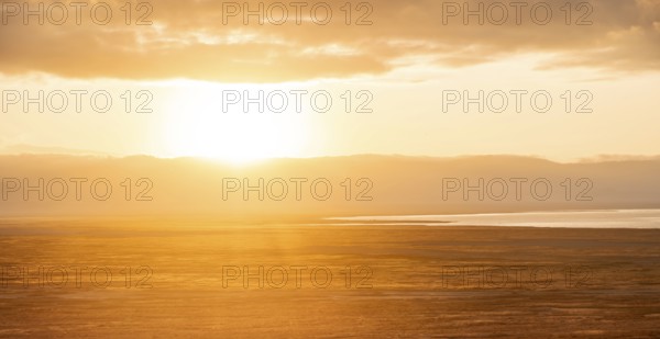 View of savanna landscape at sunrise, atmospheric morning light, view of Ngorongoro Crater, back light, Ngorongoro Conservation Area, Tanzania