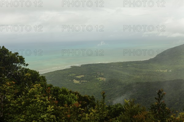 Distant tropical view from Mount Sorrow across valley and bay to where the Great Barrier Reef meets the coast Queensland, Australia