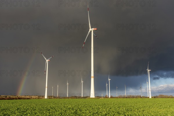 Königshovener Höhe onshore wind farm, on the A44 motorway near Bedburg, in front of the Jackerath triangle, autumn, rainbow, dark rain clouds, recultivated open-cast mining area, Garzweiler open-cast lignite mine, operated by RWE and the city of Bedburg, North Rhine-Westphalia, Germany