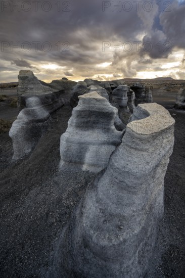 Eroded rock formations, volcanic landscape with dramatic cloudy sky at sunset, Ciudad Estratificada or Los Roferos, Antigua Rofera de Teseguite, Lanzarote, Canary Islands, Spain