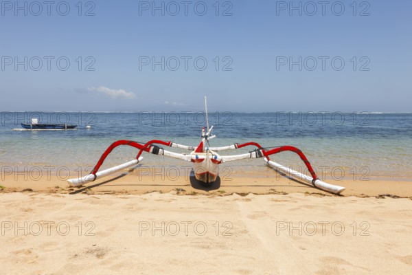 Colourfully painted outrigger fishing boats, (Junkung), on Sanur beach, Bali, Indonesia