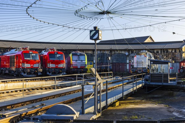 Turntable and overhead line spider, behind it modern locomotives of the Austrian Federal Railways, ÖBB, and Deutsche Bahn, DB, parked in front of the old lock shed, Augsburg railway park, administrative district of Swabia, Bavaria, Germany