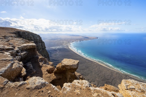 View from the Risco de Famara Cliff to Famara Beach, Playa de Famara with La Calaeta, Lanzarote, Canary Islands, Spain