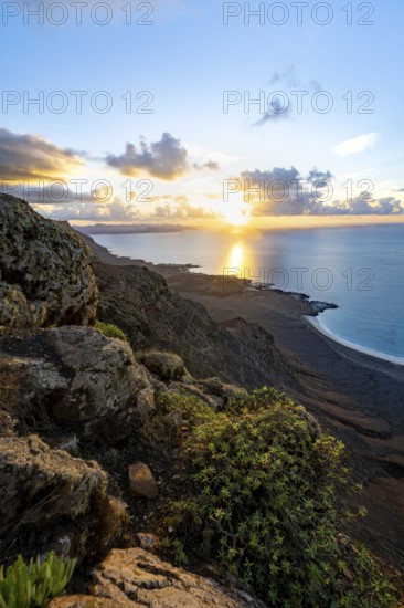 View of steep cliffs on sea and coast, Mirador del Porrito viewpoint at sunset, Lanzarote, Canary Islands, Spain