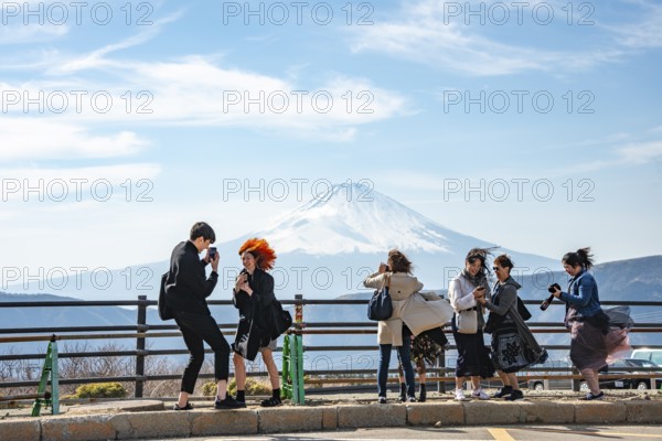 Tourists enjoy the view and take pictures, view of the snow-covered summit of Mount Fuji volcano in spring, Owakudani, Hakone, Japan