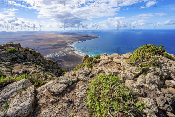 Castillejo viewpoint, view from the Risco de Famara cliffs to the coast and the sea with the Famara beach, Playa de Famara, Lanzarote, Canary Islands, Spain
